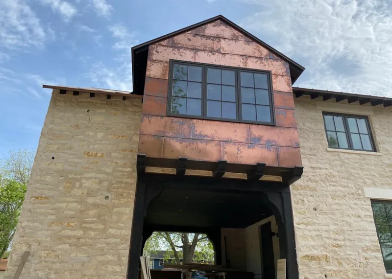 Copper metal panel facade on a stone building for Roof Repair in Kerrville